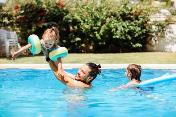 imgi 34 cute little girl having fun with parents in pool